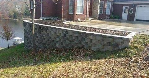 Brick retaining wall with white metal handrail — residential project